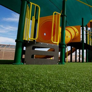 Artificial playground grass with yellow play equipment in New Jersey