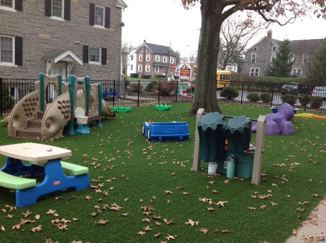 Childrens play area on artificial playground grass in New Jersey