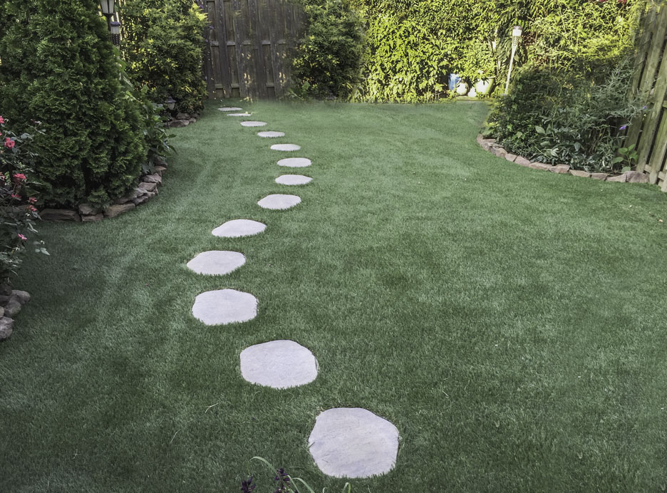 Stone pathway winding through a synthetic lawn in PA